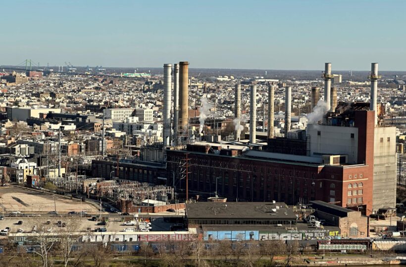 An aerial shot of Philadelphia focusing on a factory building with smokestacks