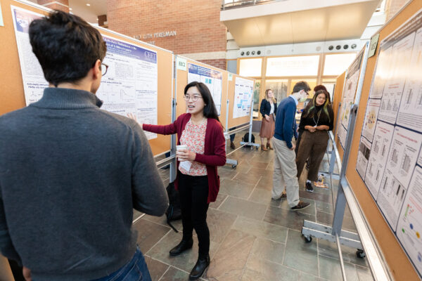 Trainees participating in a poster presentation, sharing their research projects