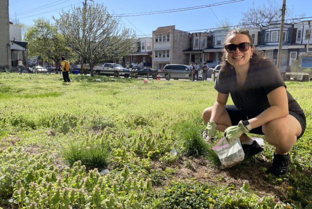 Student collecting a soil sample from a field in Philadelphia. The soil will be tested for lead and other hazardous materials.