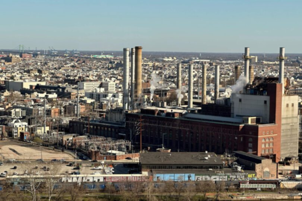 An aerial shot of Philadelphia focusing on a factory building with smokestacks