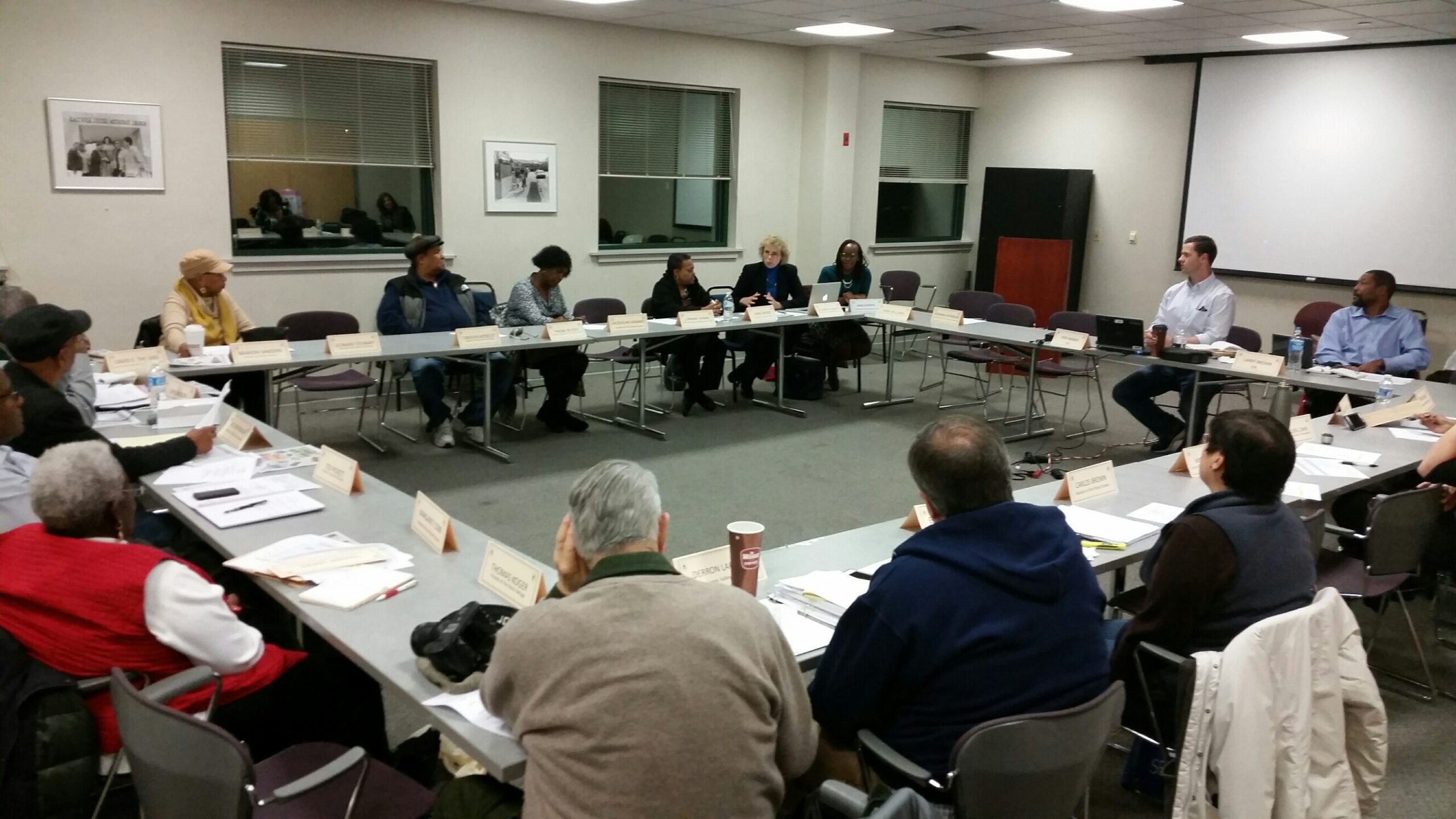 Members of a Community Organization meeting around a conference table