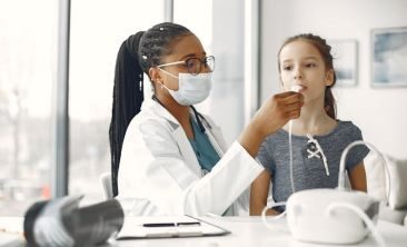 Physician performing test on young girl