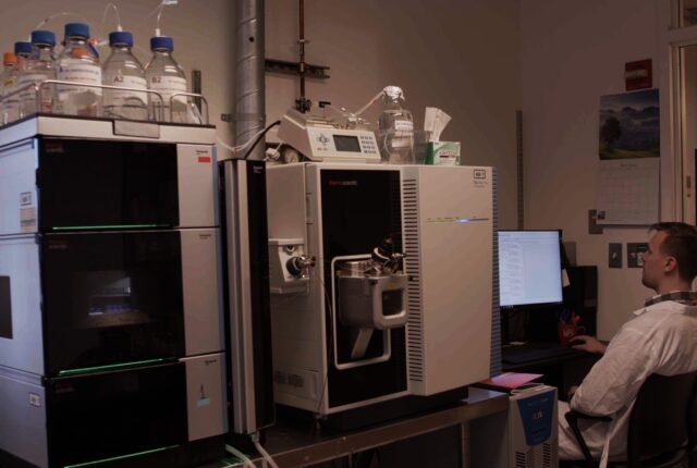 Researcher viewing data produced from a mass spectrometer