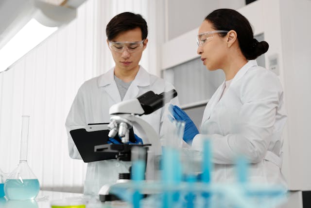 Researchers Wearing Lab Coats and Protective Goggles