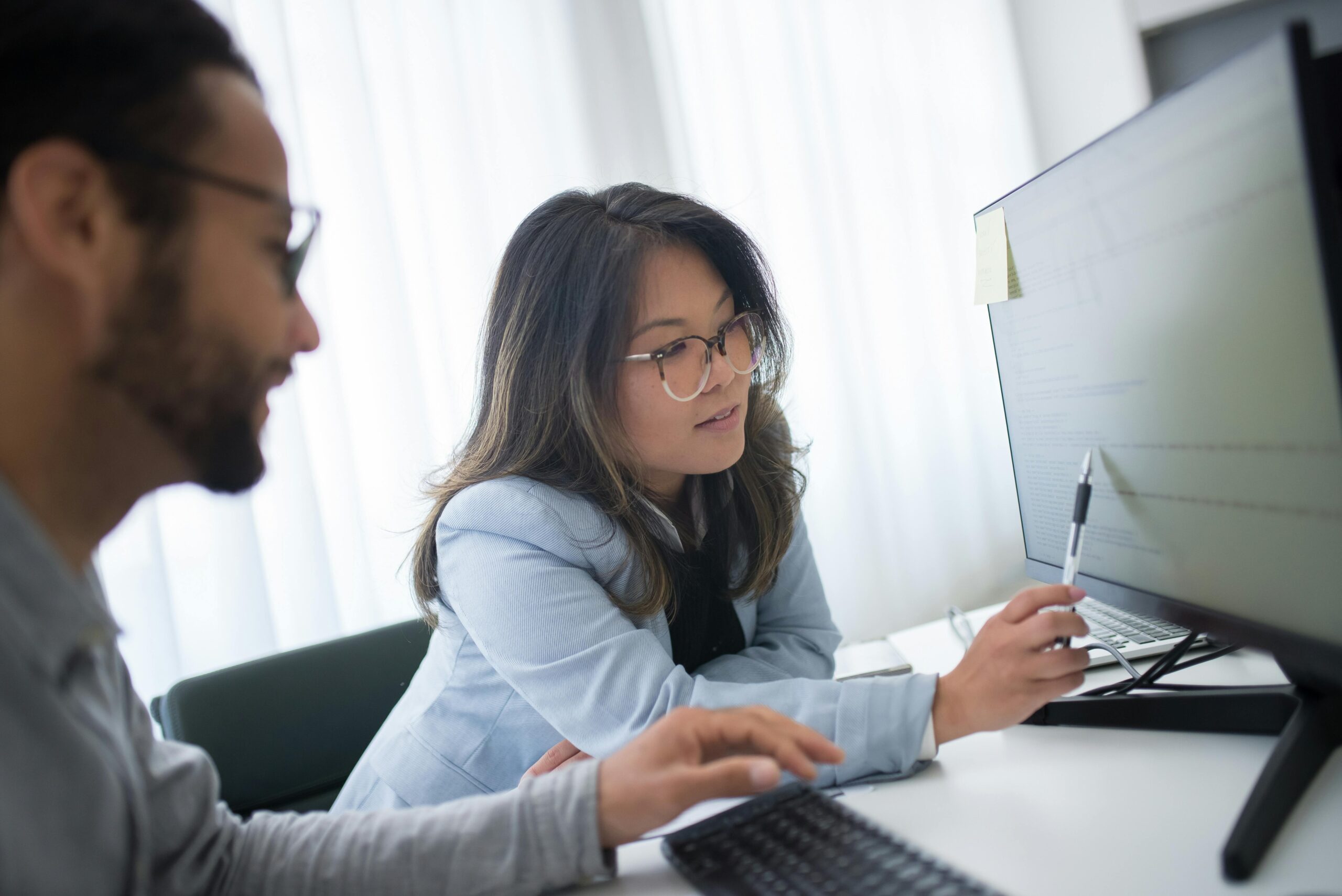 Two people working together at a computer